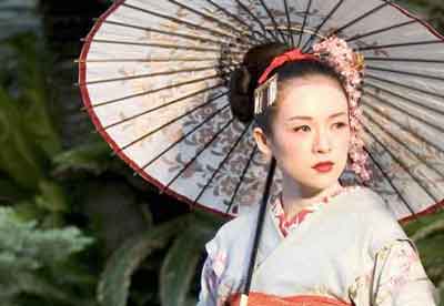 Sayuri with a japanese umbrella in the garden, beautiful woman